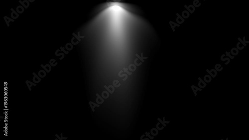 Spotlight beam shining down on black background with light smoke