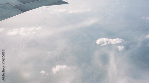 View from Airplane Window, Flying Above Clouds