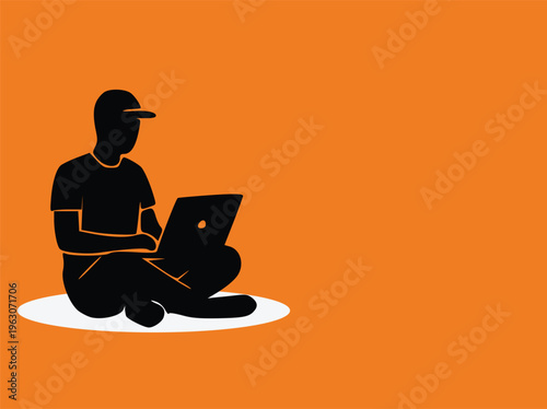 Silhouette of a man sitting on the floor working on a laptop computer