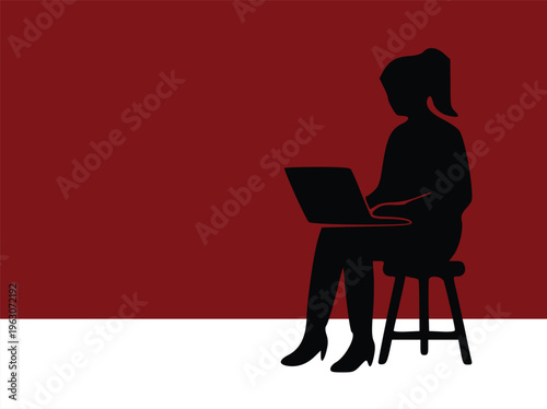 Silhouette of a woman working on a laptop sitting on a stool