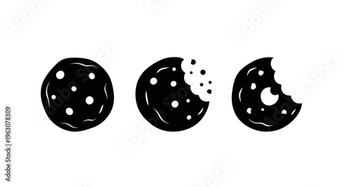 Three black and white cookies showing different stages of being eaten.