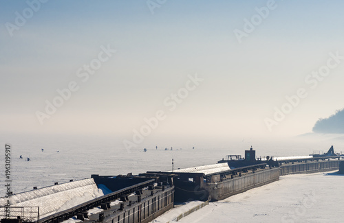Winter barge mooring landscape and ice fisherman.