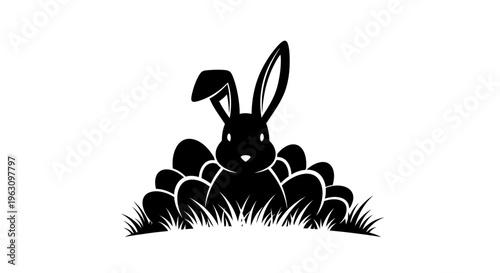 Black silhouette of an Easter bunny surrounded by Easter eggs in grass.
