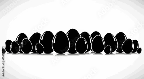 Collection of glossy black eggs arranged in a row on a white background.