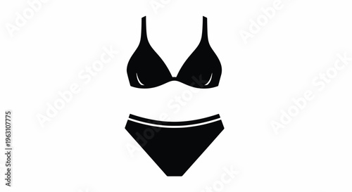 Black bikini with thin straps and briefs on a plain surface
