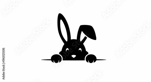 Cute black bunny peeking over a surface with one ear up.