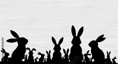 Silhouettes of various rabbits and bunnies in a row.