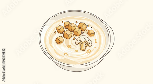 Creamy soup with croutons and a cauliflower floret