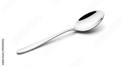 Shiny silver stainless steel teaspoon isolated on a white background as a single metal kitchen utensil and cutlery tool for cooking or dinner