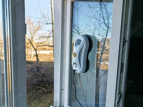 A window cleaning robot at work. A window being washed by a window cleaning robot.