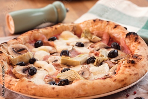 Delicious homemade pizza sits invitingly on a plate, adorned with fresh mushrooms, artichokes, and olives. This meal represents warmth and love, perfect for tough financial times