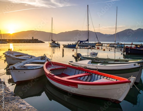 Wallpaper Mural Sunrise bathes a calm harbor; small boats bob peacefully near docks. Mountains frame the horizon, reflecting in the water Torontodigital.ca