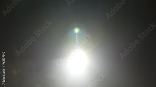 Bright green spotlights cut through the dark atmosphere of an empty stage or venue. The dynamic beams create circular patterns on the floor, evoking an energetic mood for a concert or live event.
