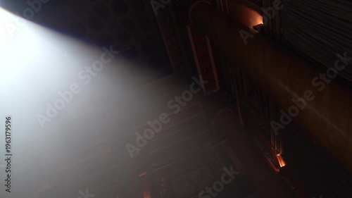 Bright green spotlights cut through the dark atmosphere of an empty stage or venue. The dynamic beams create circular patterns on the floor, evoking an energetic mood for a concert or live event.
