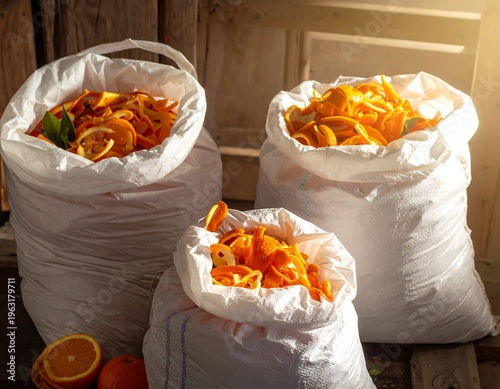 Wallpaper Mural Three bags overflow with orange peels, lit by sunlight. A whole orange sits nearby Torontodigital.ca