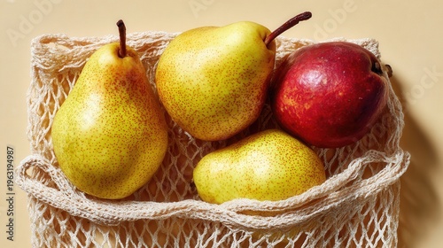 Fresh pears and one red fruit in a white mesh shopping bag, representing sustainable living and natural healthy food choices