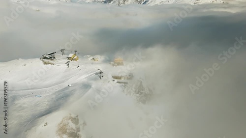 Aerial view of Swiss Alps mountain range through clouds in Zermatt Switzerland winter