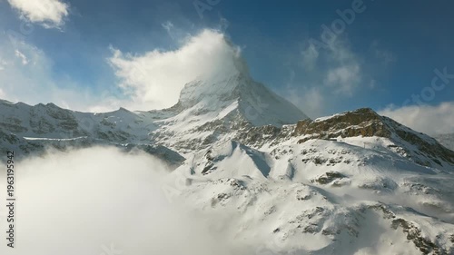 Aerial drone view of Matterhorn and Swiss Alps glaciers above clouds in Zermatt Switzerland