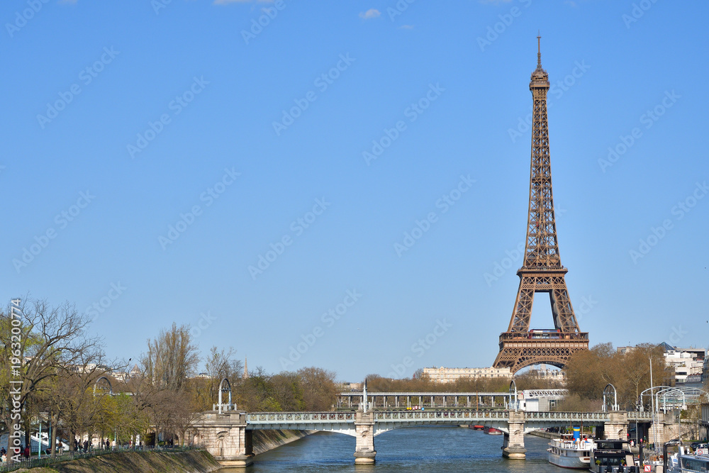 Fototapeta premium Eiffel Tower seen from the Seine near Pont de Grenelle in Paris, France, March 15, 2026