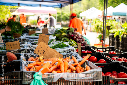 Cuadro en lienzo A colorful farmers market produce stand displays fresh carrots, leafy greens, and mixed vegetables with price signs, a vibrant scene of local food culture