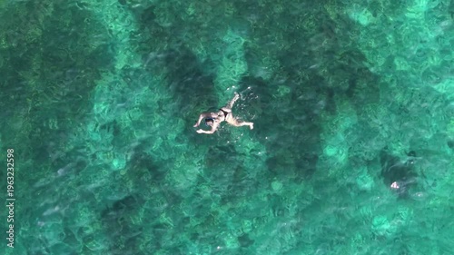 Top Down Aerial View of Woman Snorkeling in Turquoise Water Ko Tao Thailand