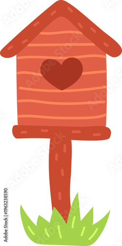 Wooden birdhouse with heart symbol standing in grass