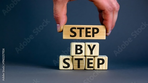 A hand holding wooden blocks with step by step text on a dark background on transparent background