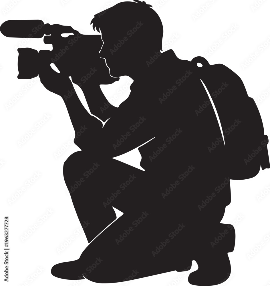 Naklejka premium A male videographer kneeling down while filming with professional equipment