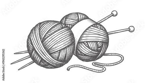Two balls of grey yarn with knitting needles and a loose strand wool craft