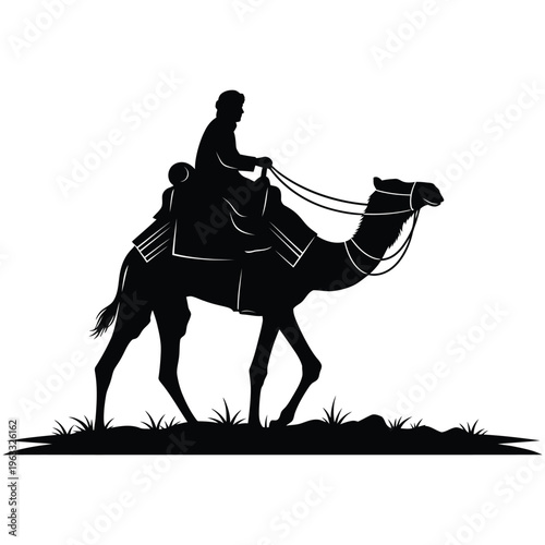 Black silhouette of a man riding a camel across grassy terrain