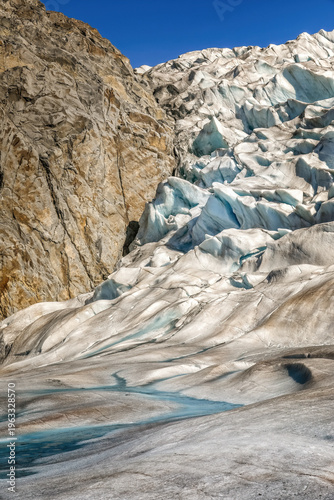 A rock surrounded by glacial ice on the Mendenhall glacier, Alaska