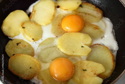 Making sunny side up eggs with fried potato