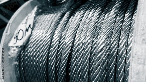 Obraz na plátně A coil of strength — braided metal cable surface fills the frame with precise ge