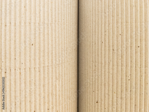Two corrugated cardboard sheets placed side by side, fine vertical ribbing fills the frame