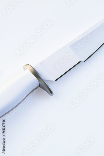A single knife with a black handle placed on a clean white surface