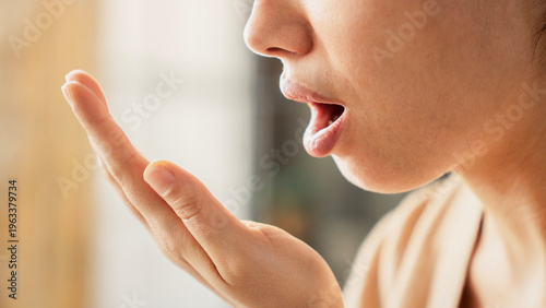 Fotografía Woman is checking smell of breath