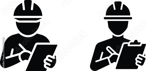 Two workers in hard hats holding clipboards and making notes on site plans