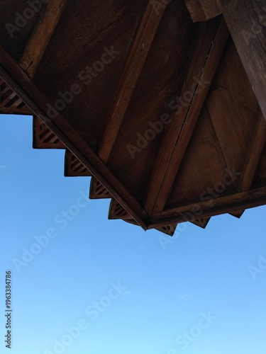 Gazebo roof detail in outdoor setting, classic wooden pavilion structure.