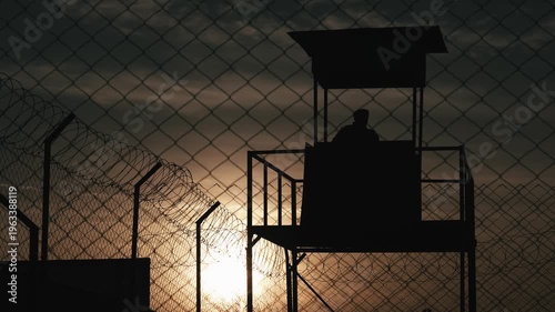 Prison Wall with Guard Tower Silhouette. Military seclusion and restricted areas video.