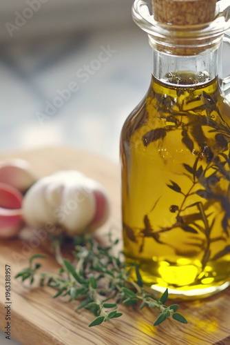 A bottle of olive oil and garlic on a kitchen cutting board, great for cooking and baking