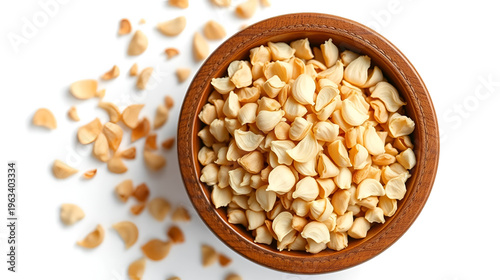 Dried garlic granules in wooden bowl. Allium sativum, with its pungent flavor is used as seasoning or condiment and also in medicine. Isolated macro food photo, closeup from above on white background.