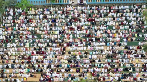 Muslim people kneeling during outdoor eid prayer in bangladesh