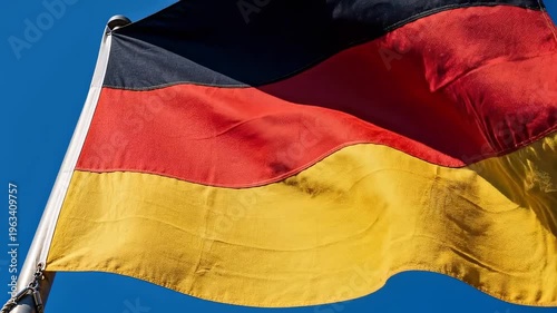 German flag waving in a clear blue sky outdoors