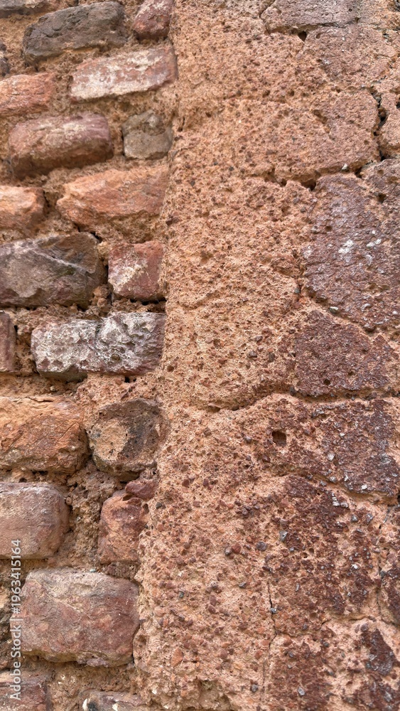Fototapeta premium Two Distinct Weathered Wall Textures Separated by an Uneven Vertical Seam