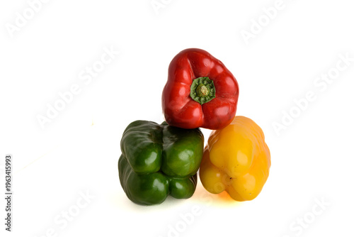 Three Color Bell Peppers Stacked Red Green And Yellow Fresh Vegetables On White Background