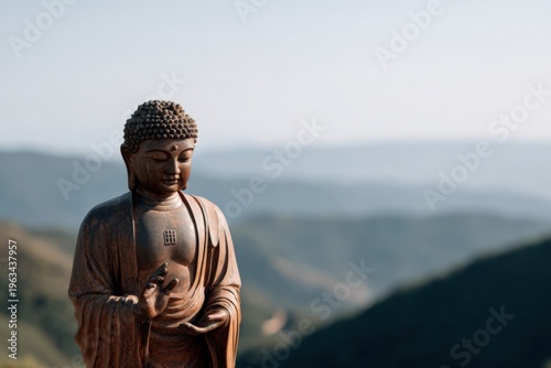 Buddha statue meditation bronze mountain backdrop with soft morning light serene contemplative scene showing asian male adult likeness overlooking misty valley at sunrise