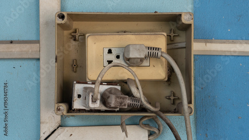 Junction box containing electrical blocks and crisscrossing wires. The missing plastic lid reveals a potentially unsafe and disorganized installation.