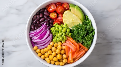 Longevity diet concept, A vibrant, healthy bowl filled with chickpeas, black beans, cherry tomatoes, avocado, lime, kale, red onion, edamame, and shredded carrots on a marble surface.