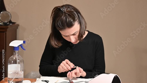 Young woman doing manicure at home