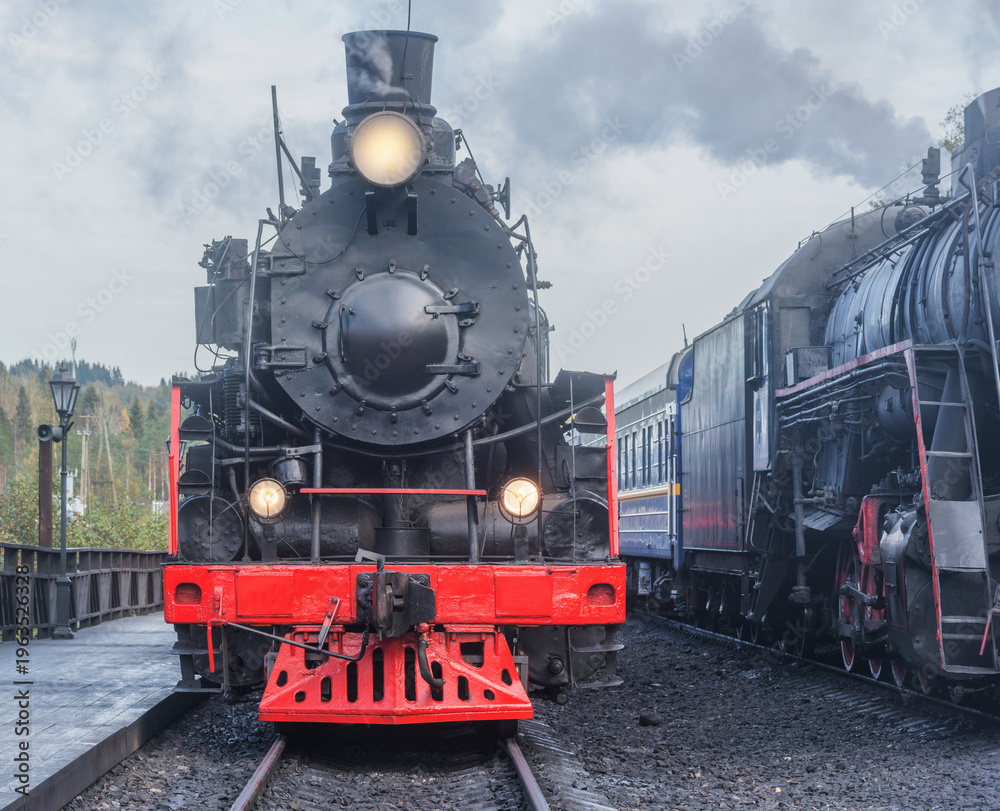 Fototapeta premium Old steam train stands by the platform. 
